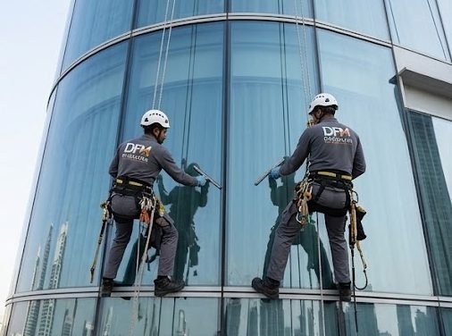 Rope access technicians on curved glazing